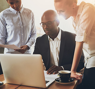 Business people around a laptop