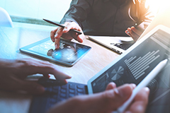 Business people around a tablet